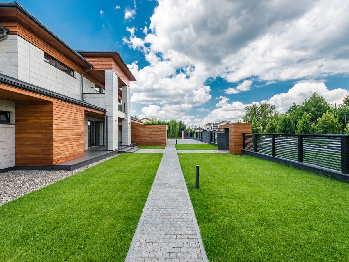 Modern residential yard with a long, freshly maintained lawn