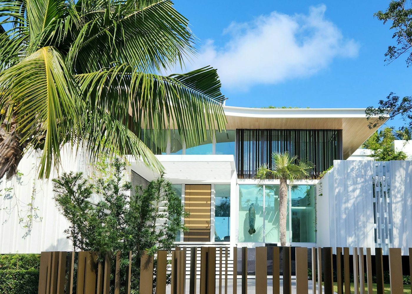 Florida home framed by palms and established greenery